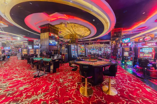 BET3999 Casino Games — Enjoy nonstop entertainment A close-up shot of golden coins falling around a spinning roulette wheel, representing immersive casino action at BET3999.