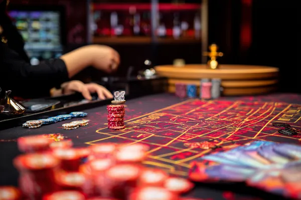 A glowing roulette wheel with cascading chips, symbolizing the engaging live and instant-win games available on BET3999.